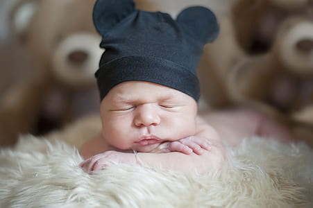 sleeping baby on white furt bed thumbnail