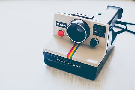 white and black One Step camera thumbnail