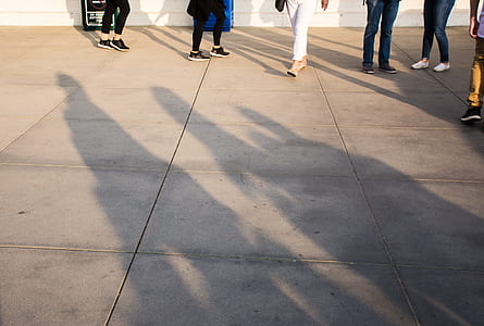 people walking on gray concrete flooring thumbnail