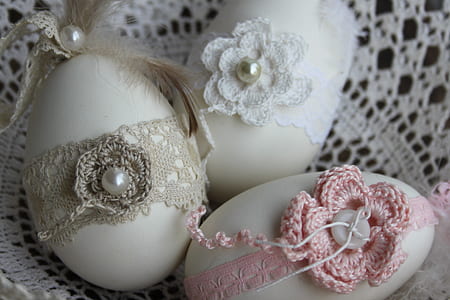 three white eggs with knitted straps thumbnail