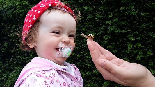 girl's biting white pacifier thumbnail