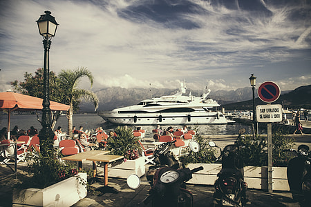 white cruise ship near red chairs during daytime thumbnail