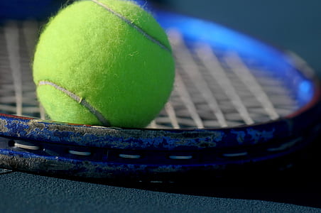 green tennis ball on rocket net thumbnail