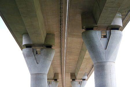 low angle photography of gray concrete bridge during daytime thumbnail