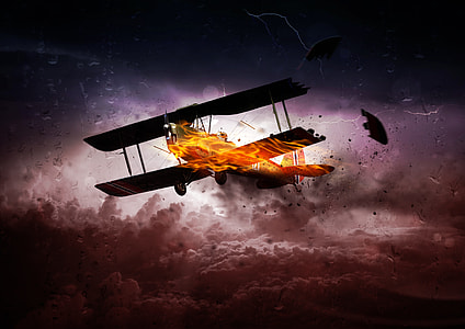 burning biplane above white and brown clouds digital wallpaper thumbnail