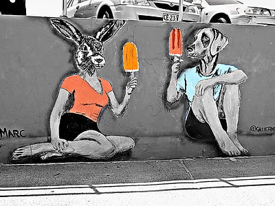 selective focus photo of mural portraying rabbit and dog sitting and holding ice pops thumbnail