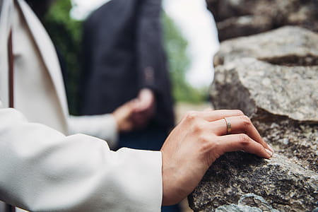 A young Caucasian couple holding each other s hands with focus on the female s ring in the foreground thumbnail
