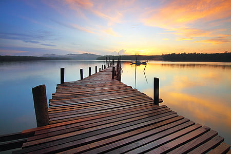 brown wooden dock surrounded by water thumbnail