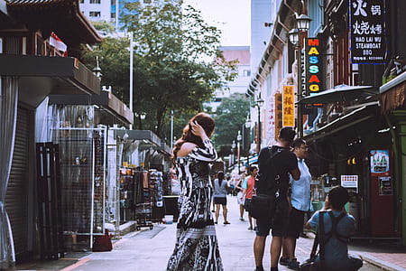 woman holding her hair while walking thumbnail