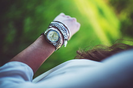 woman wearing round chronograph watch with silver-colored link bracelet thumbnail