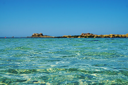 brown island on shallow waters thumbnail
