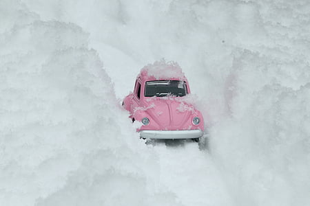 pink Volkswagen Beetle scale model on snow thumbnail