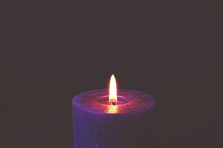lit candle in the dark thumbnail