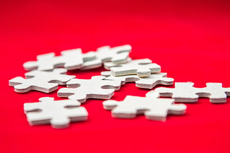puzzle pieces on red textile thumbnail