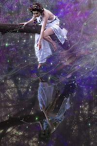 woman in white dress sitting on arch tree trunk with green lights thumbnail