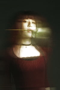 woman in red top while biting white rose thumbnail