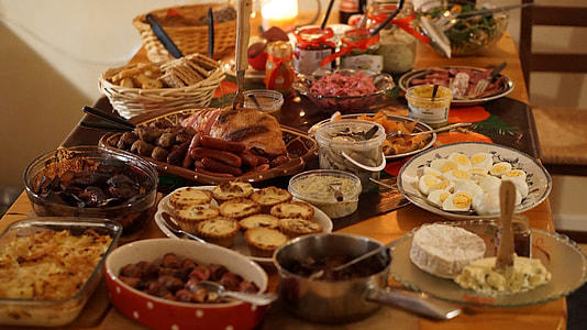 shallow focus photography of bunch of food dishes on rectangular brown wooden table thumbnail