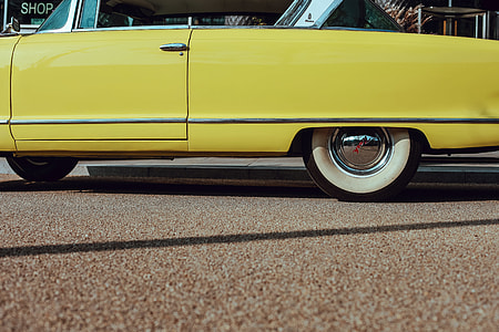 yellow coupe at daytime thumbnail