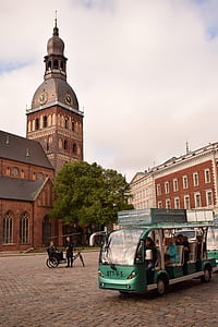 tour bus near trike and building thumbnail