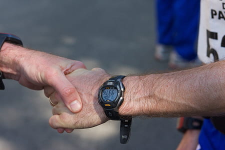 person touching person's hand wearing watch thumbnail
