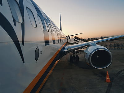 people near white, blue, and orange airplane thumbnail