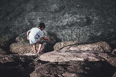 Boy Playing With Stick Near Water thumbnail