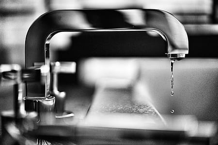 close view of stainless steel faucet dripping water thumbnail
