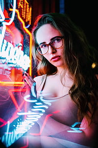 woman leaning on neon signage board thumbnail