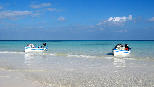 photo of two white and blue boats sailing in open water thumbnail