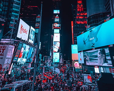 people standing beside commercial building during nighttime thumbnail