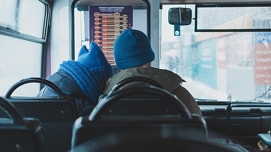 two persons sitting on black bus seat thumbnail