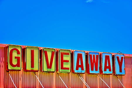 blue, green, and red Give Away signage during daytime thumbnail