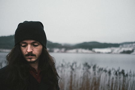 man standing near body of water thumbnail