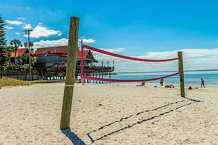 red and white volleyball net on the beach thumbnail