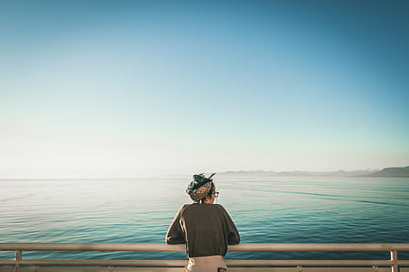 selective focus of woman standing near body of water thumbnail
