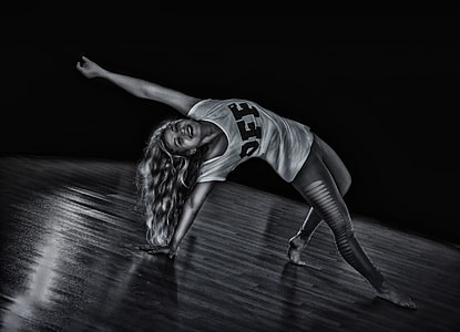 grayscale photo of woman wearing shirt and pants dancing thumbnail