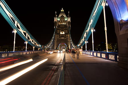people walking on concrete bridge at nighttime thumbnail