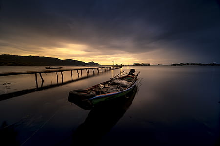 brown boat on body of water thumbnail