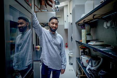 man standing near black wine cooler thumbnail