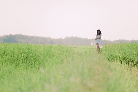 Woman Standing on Grass Field thumbnail