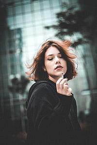 woman holding used cigarette thumbnail