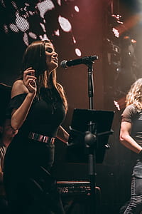 woman performing on stage on front of microphone with stan thumbnail