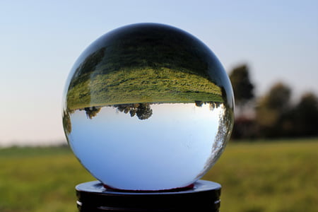 clear crystal ball near green grass field thumbnail
