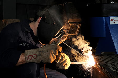 man wearing black holding helmet and black jacket thumbnail