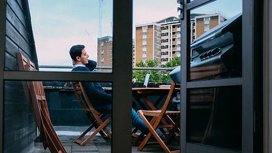 man sitting on chair outdoors thumbnail