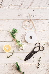 scissor and slice lemon on beige wooden surface thumbnail