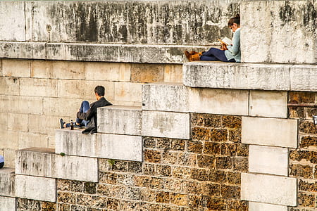 man and woman sitting on gray concrete stairs thumbnail