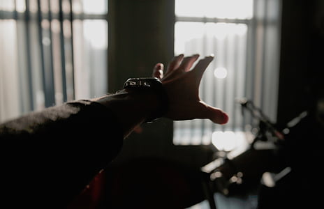 person raising hand wearing watch inside house shallow focus photography thumbnail
