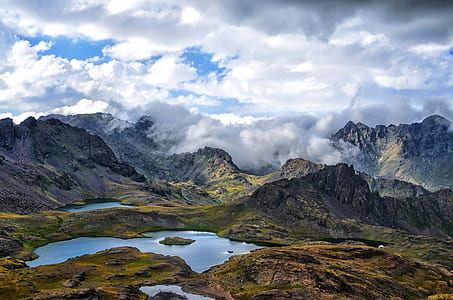 photography of brown and grey lake near mountain during daytime thumbnail