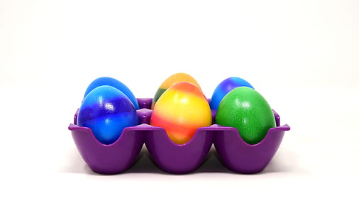 six assorted-color easter eggs on purple tray thumbnail
